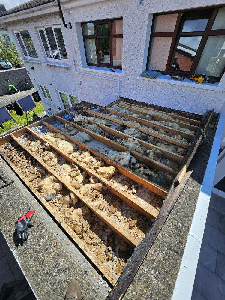 Flat roof before repair showing damage and wear